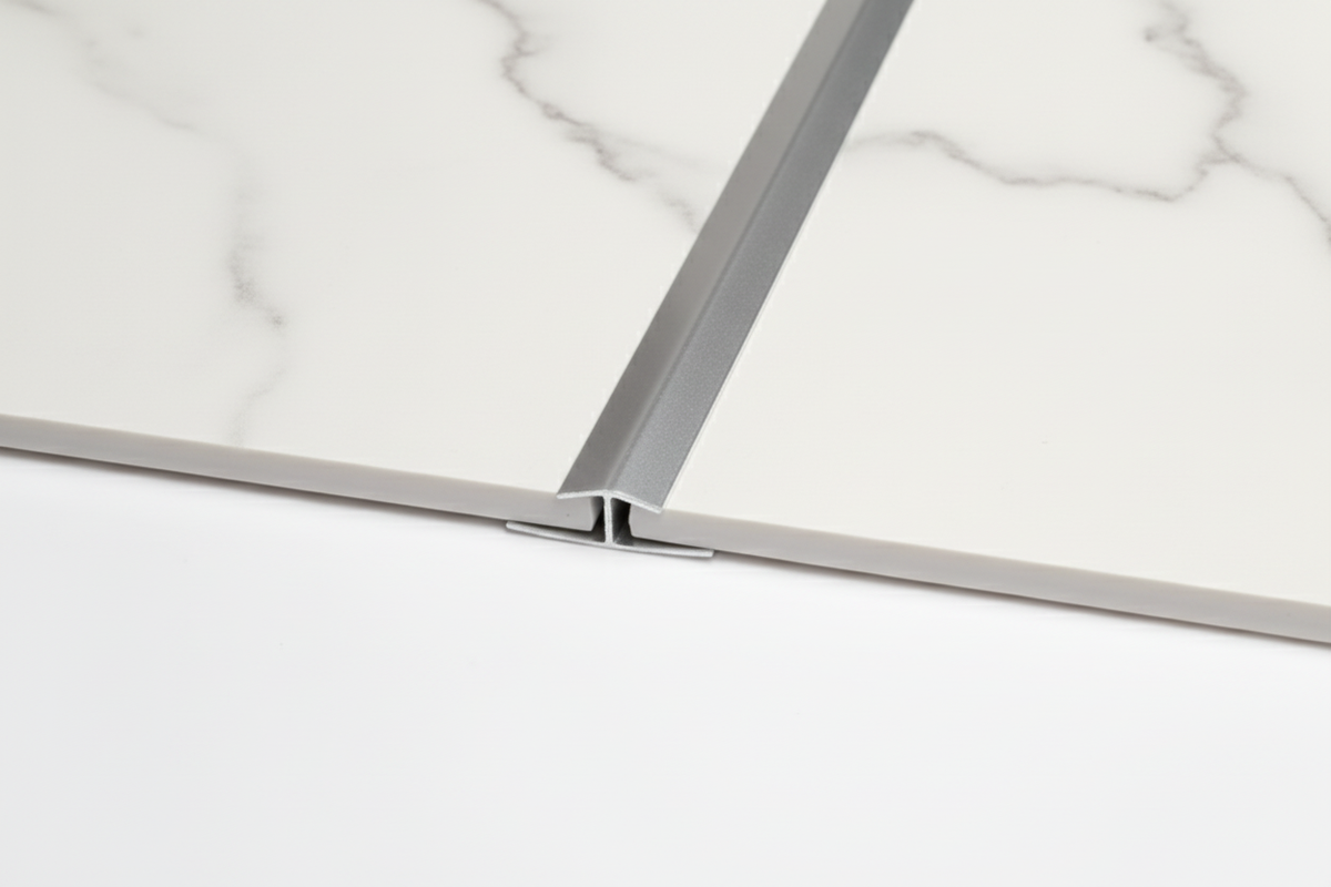 Silver H Trim installed between white marble panels